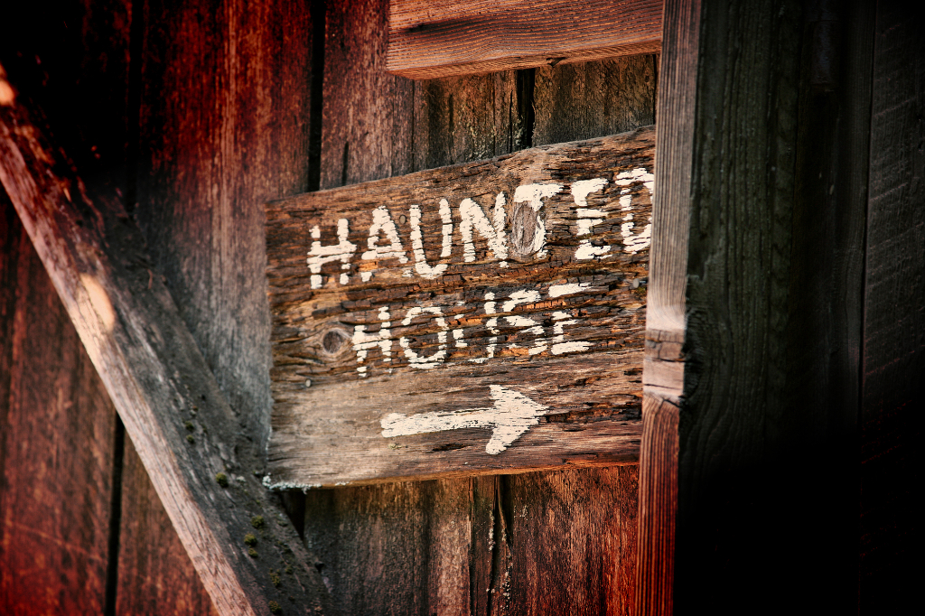 Haunted house direction witten on wooden door
